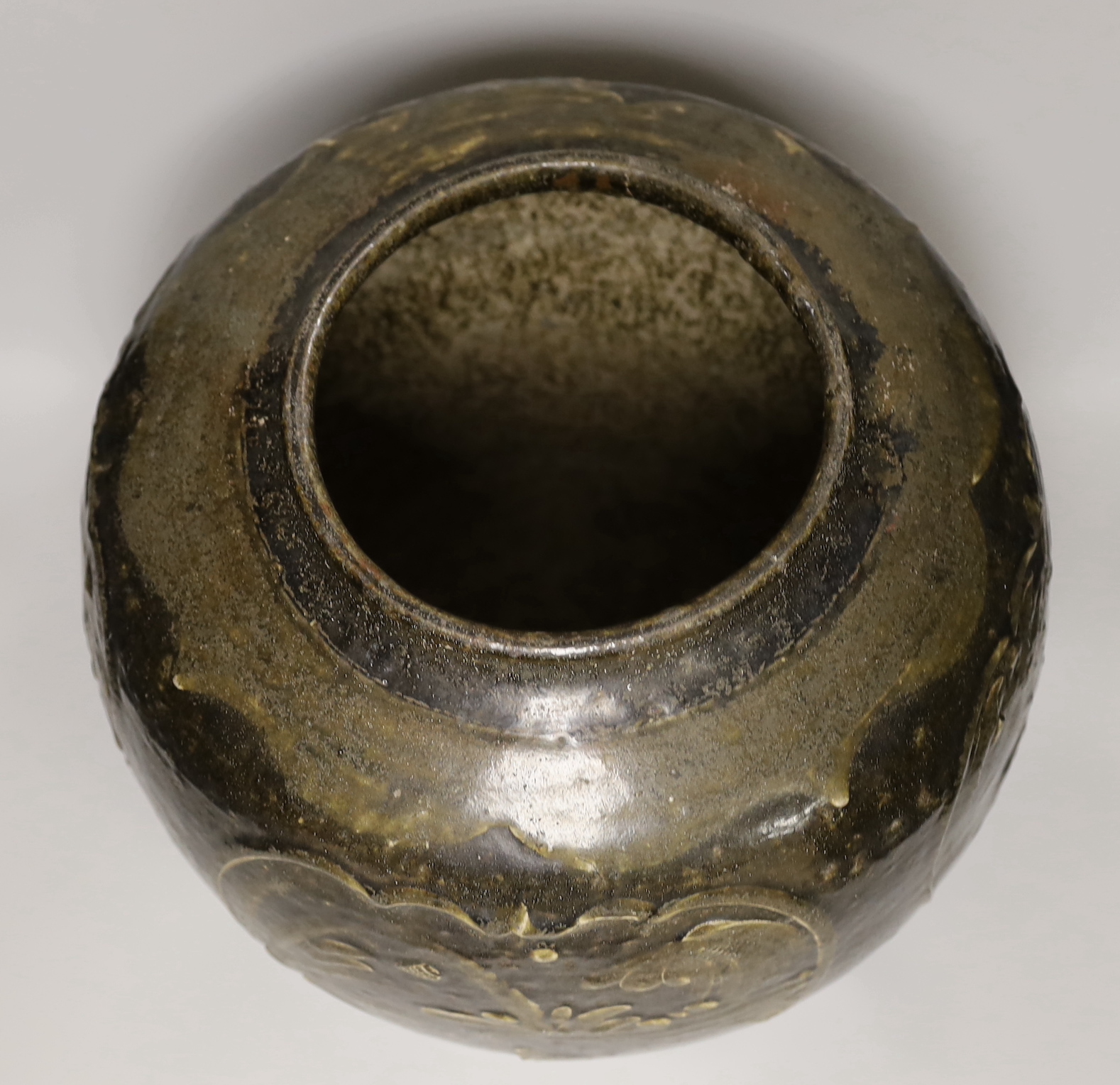 A large Chinese stoneware ovoid jar, decorated in relief with birds and flowers, possibly 19th century, 36cm high